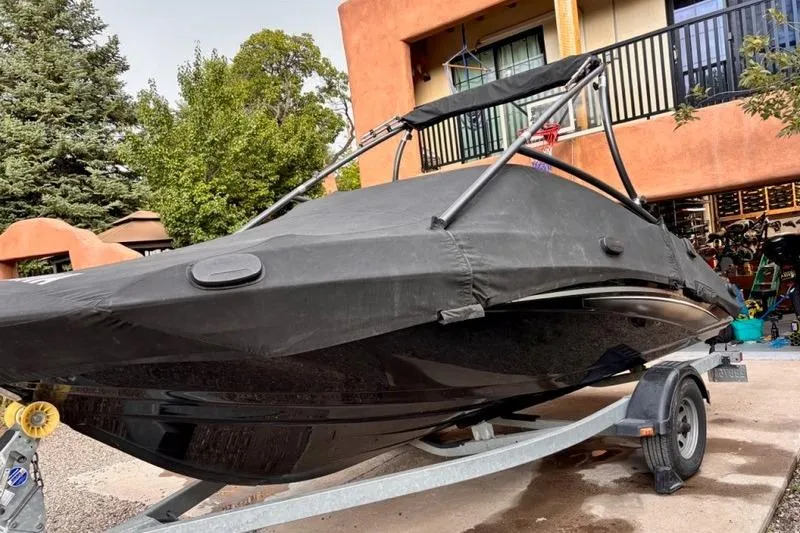 Slide: The Image of 2013 Yamaha AR192 boat covered on trailer, parked in residential driveway. - 4