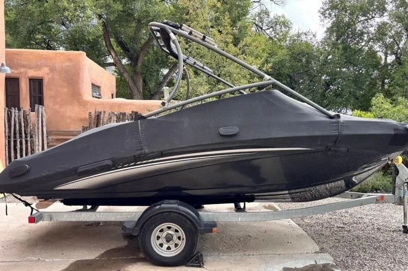 Slide: The Image of 2013 Yamaha Boats AR192 covered on trailer, parked outdoors. - 5