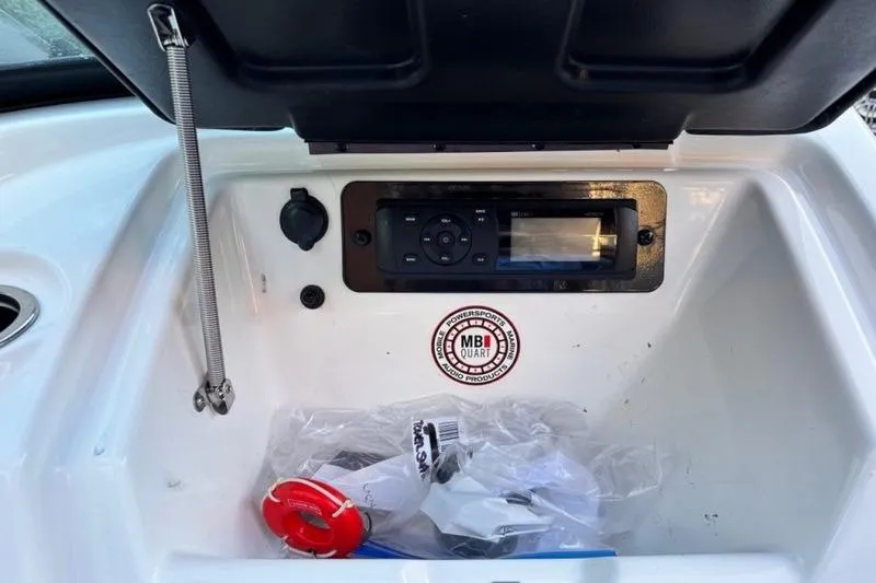 Slide: The Image of 2013 Yamaha Boats AR192 dashboard with audio system and storage compartment. - 8