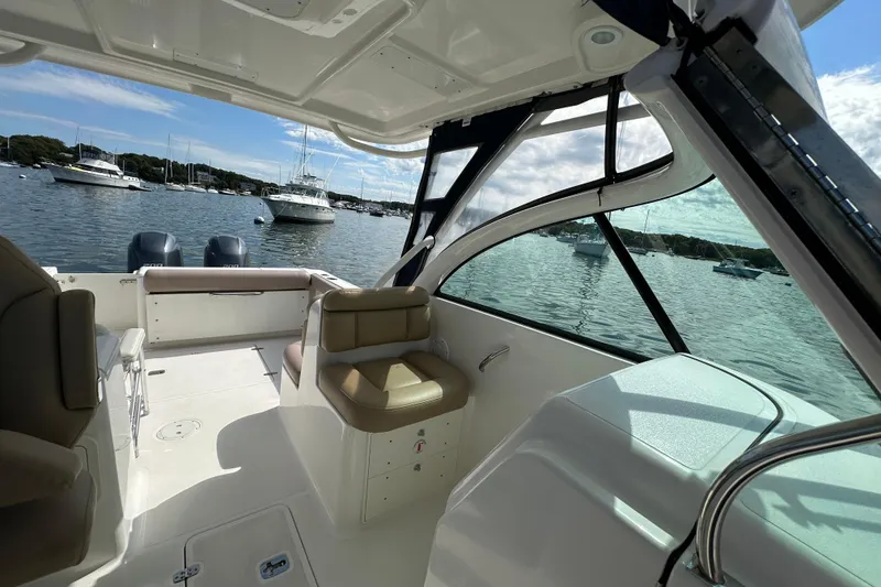 Slide: The Image of 2015 Pursuit DC 265 Dual Console boat interior with scenic harbor view. - 14