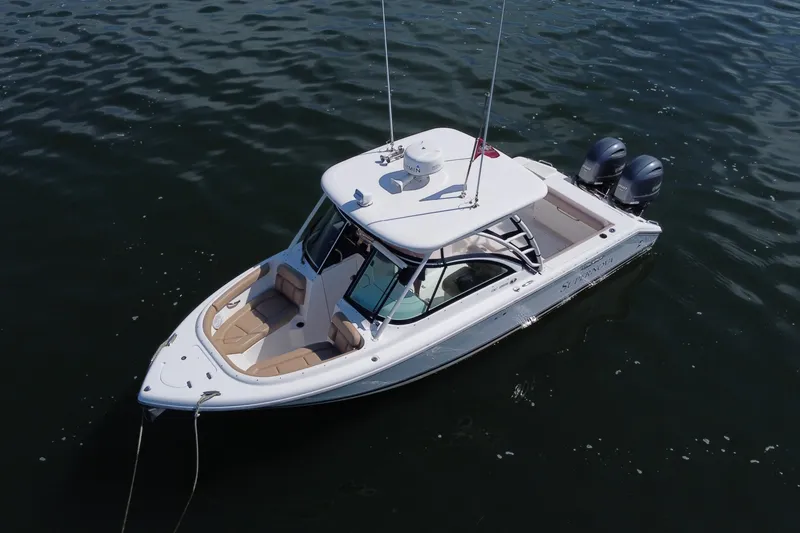 Slide: The Image of 2015 Pursuit DC 265 Dual Console boat on calm water, aerial view. - 6