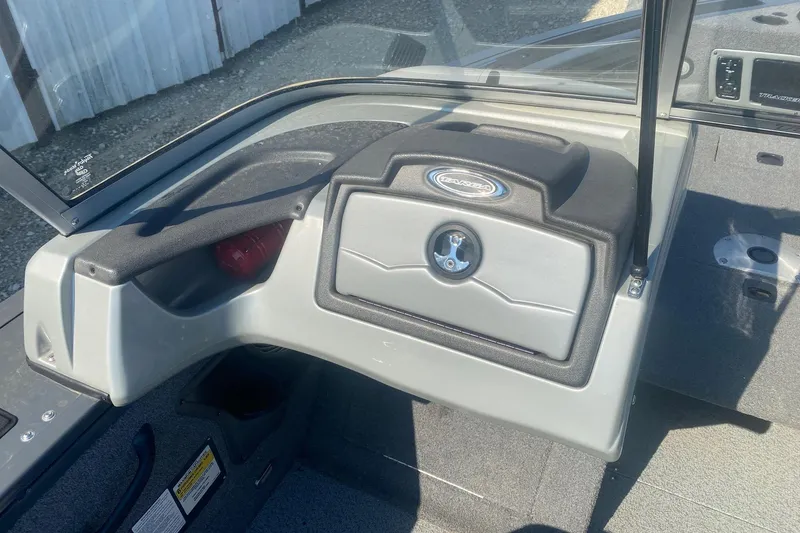 Slide: The Image of 2017 Tracker Targa V-18 WT boat dashboard with storage compartment and steering wheel. - 10