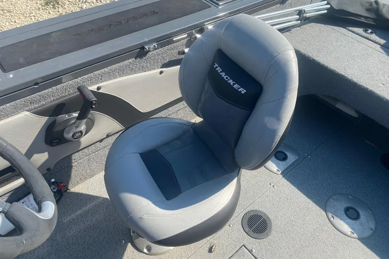 Slide: The Image of 2017 Tracker Targa V-18 WT boat interior with gray seating and steering controls. - 11
