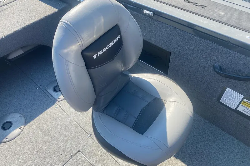 Slide: The Image of 2017 Tracker Targa V-18 WT boat seat, gray upholstery, on deck. - 12