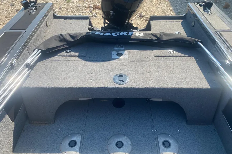 Slide: The Image of 2017 Tracker Targa V-18 WT boat interior with gray carpet and storage compartments. - 14