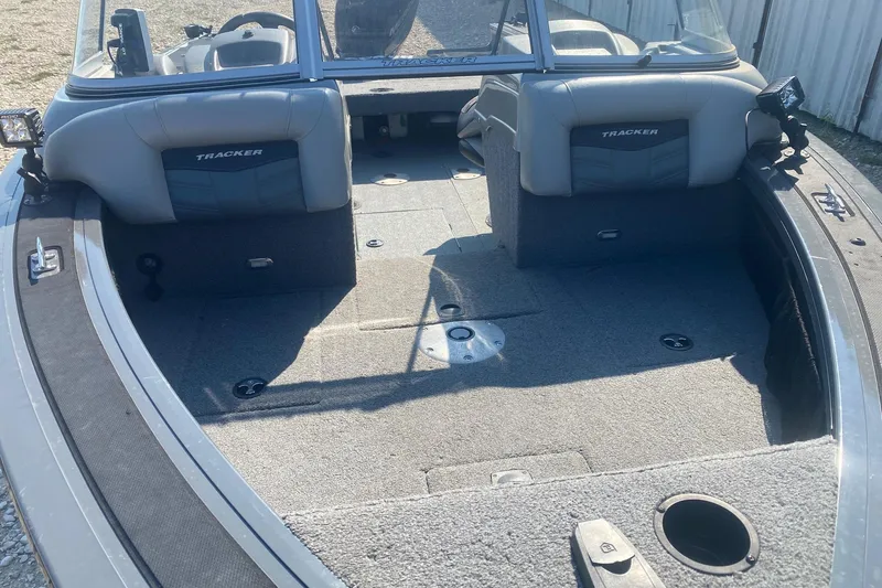 Slide: The Image of 2017 Tracker Targa V-18 WT boat interior with gray seating and carpeted flooring. - 6