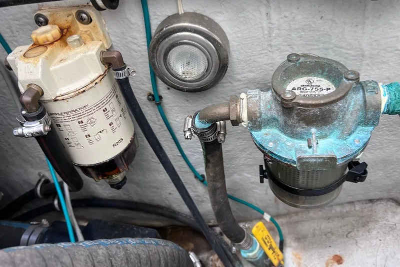 Slide: The Image of Fuel filters and hoses in a 2005 Century 3200 Walk-Around boat engine compartment. - 14