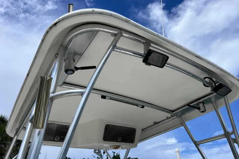 Slide: The Image of 2005 Century 3200 Walk-Around boat's T-top with mounted lights and rod holders. - 17