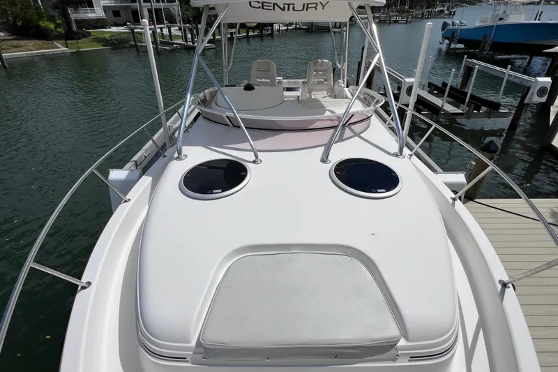 Slide: The Image of 2005 Century 3200 Walk-Around boat docked, featuring spacious deck and sleek design. - 21