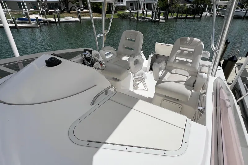 Slide: The Image of 2005 Century 3200 Walk-Around boat interior with helm and seating area. - 24