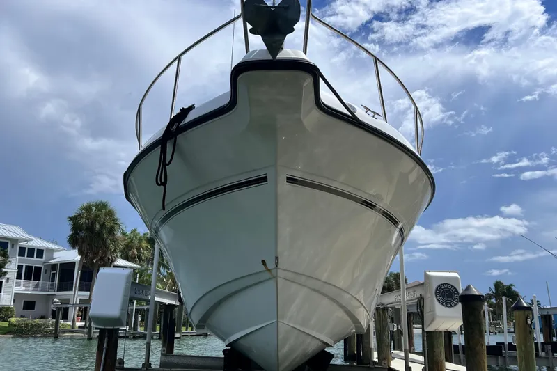 Slide: The Image of 2005 Century 3200 Walk-Around boat docked under a clear blue sky. - 3