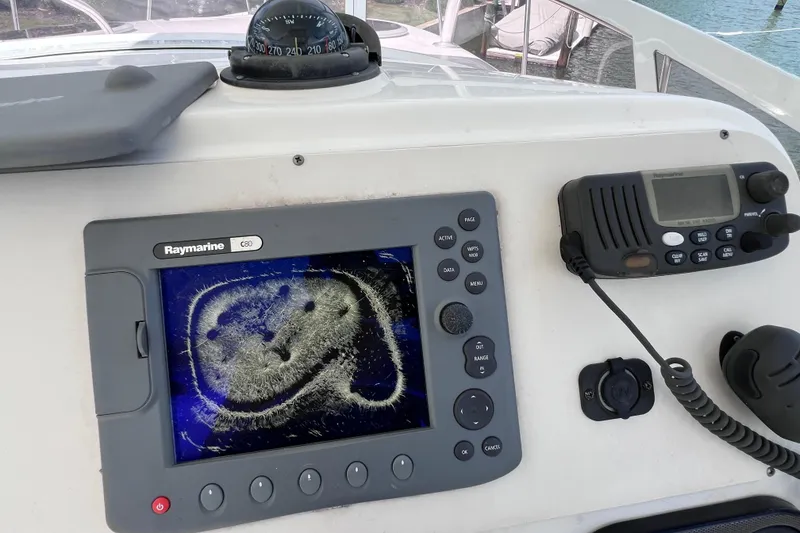 Slide: The Image of Boat dashboard with Raymarine C80 display and marine radio on a 2005 Century 3200 Walk-Around. - 31