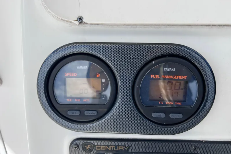 Slide: The Image of Yamaha speed and fuel management gauges on 2005 Century 3200 Walk-Around boat dashboard. - 32