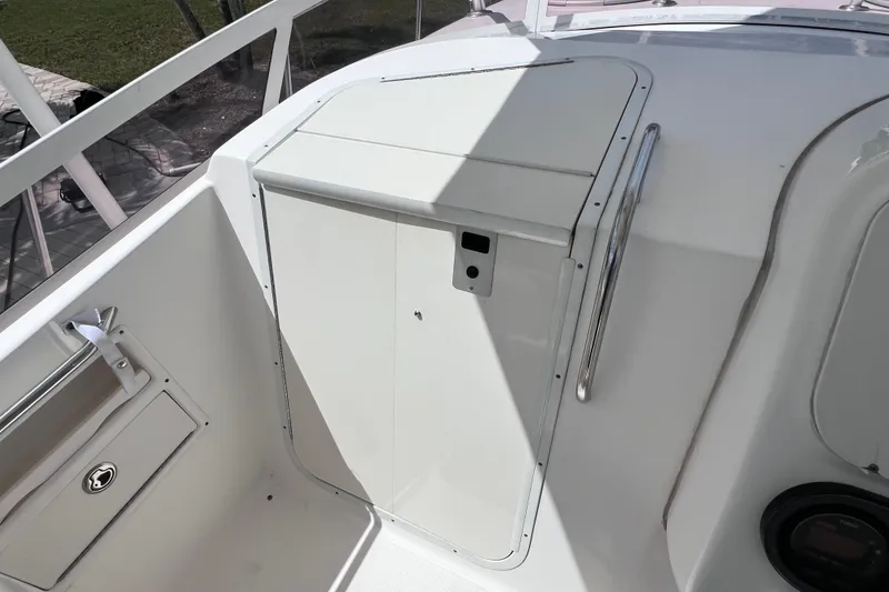 Slide: The Image of 2005 Century 3200 Walk-Around boat interior with storage compartment and railing. - 36