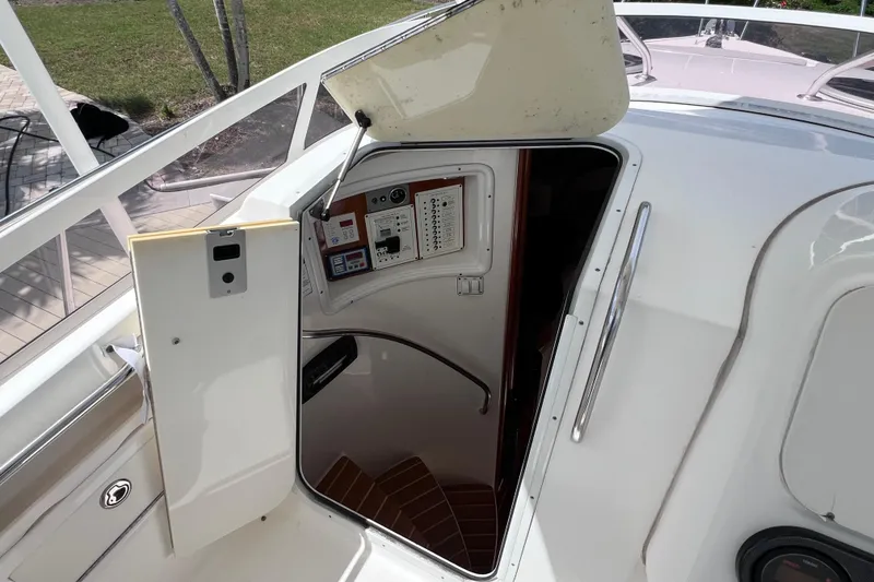 Slide: The Image of 2005 Century 3200 Walk-Around boat cabin entrance with open hatch and control panel. - 37