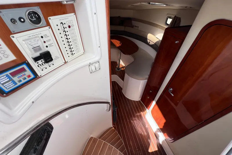 Slide: The Image of Interior of 2005 Century 3200 Walk-Around boat with control panel and seating area. - 38