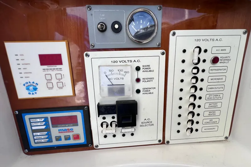 Slide: The Image of Control panel of a 2005 Century 3200 Walk-Around boat with various switches and gauges. - 39