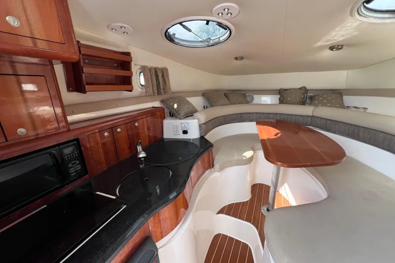Slide: The Image of 2005 Century 3200 Walk-Around cabin interior with kitchenette and seating area. - 41