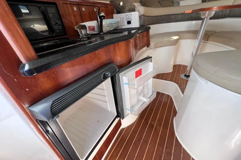 Slide: The Image of 2005 Century 3200 Walk-Around boat interior with kitchenette and seating area. - 43