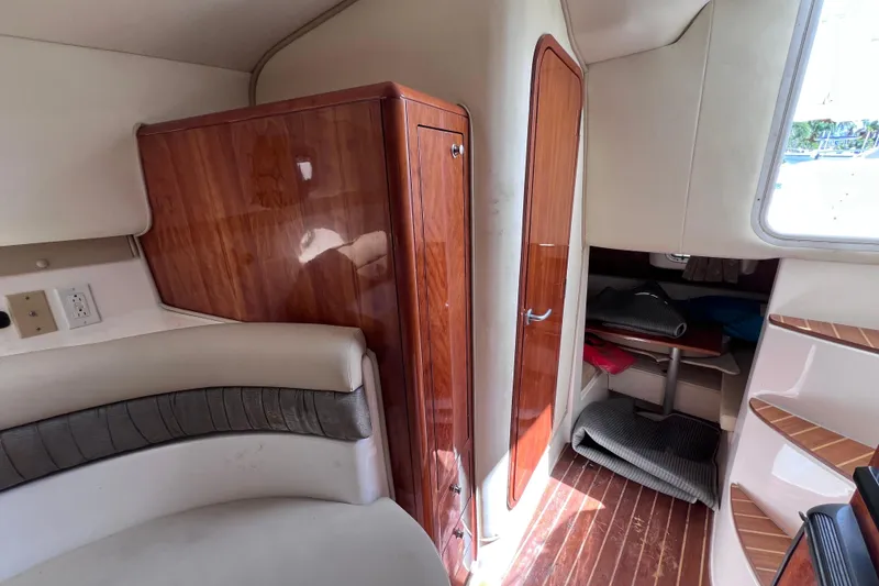 Slide: The Image of Interior of 2005 Century 3200 Walk-Around boat with wood accents and seating area. - 44