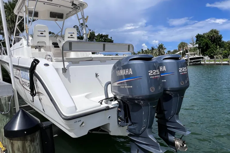 Slide: The Image of 2005 Century 3200 Walk-Around boat with twin Yamaha 225 engines docked by the water. - 5