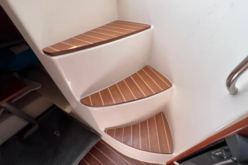 Slide: The Image of Staircase with wooden steps inside a 2005 Century 3200 Walk-Around boat. - 51
