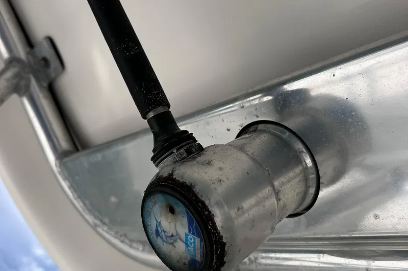 Slide: The Image of Close-up of a 2005 Century 3200 Walk-Around boat fitting with hose attachment. - 54