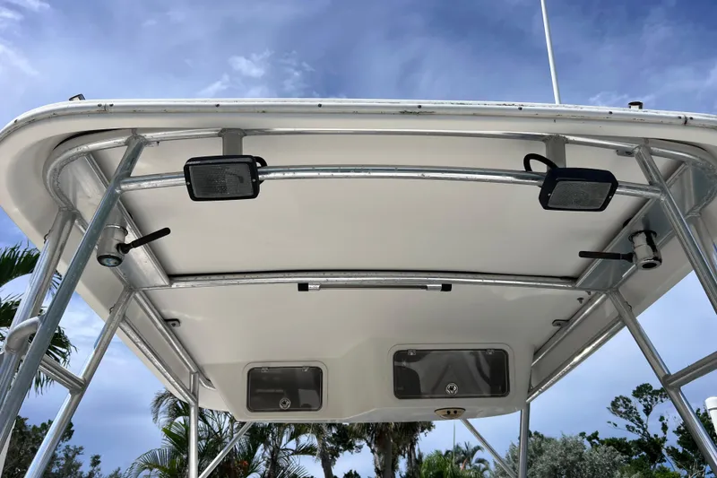 Slide: The Image of 2005 Century 3200 Walk-Around boat canopy with metal frame and lights under blue sky. - 55