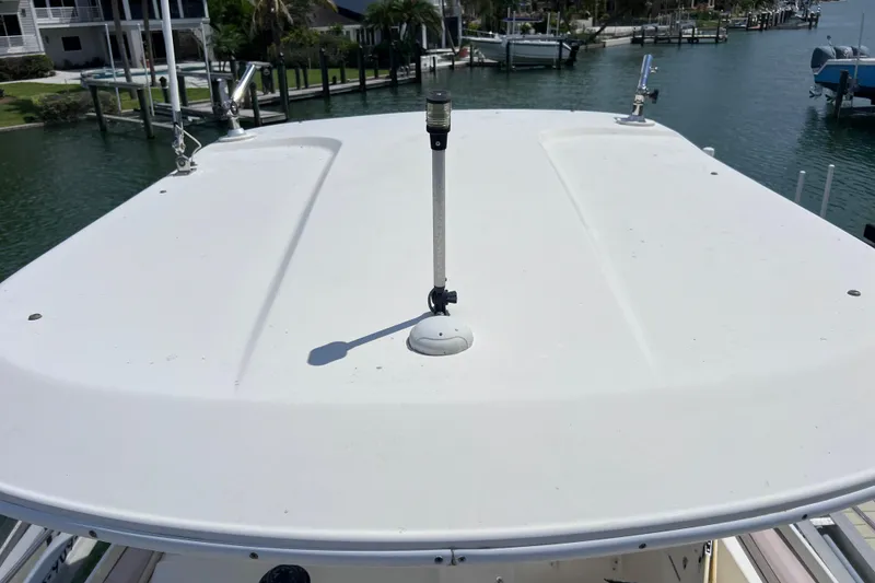 Slide: The Image of 2005 Century 3200 Walk-Around boat roof with antenna, docked in marina. - 56