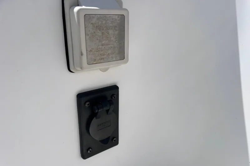 Slide: The Image of 2005 Century 3200 Walk-Around boat electrical outlets on white surface. - 58