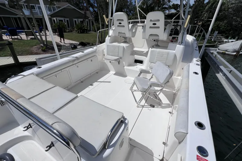 Slide: The Image of 2005 Century 3200 Walk-Around boat interior with seating and helm, docked by waterfront. - 7