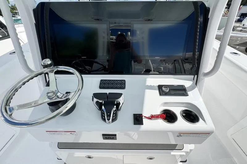 Slide: The Image of 2026 Sportsman Heritage 321 Center Console dashboard with dual screens and steering wheel. - 16