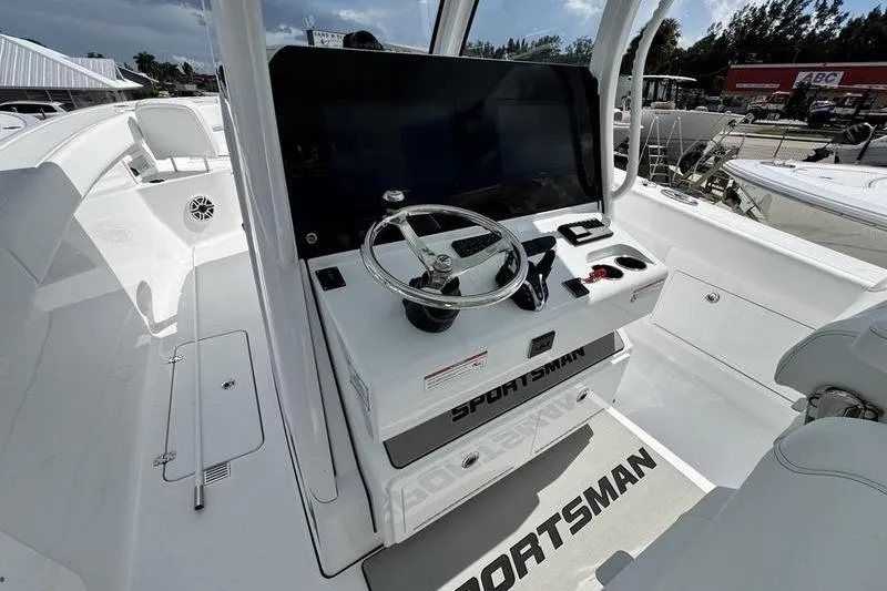 Slide: The Image of 2026 Sportsman Heritage 321 Center Console boat interior with steering wheel and controls. - 18