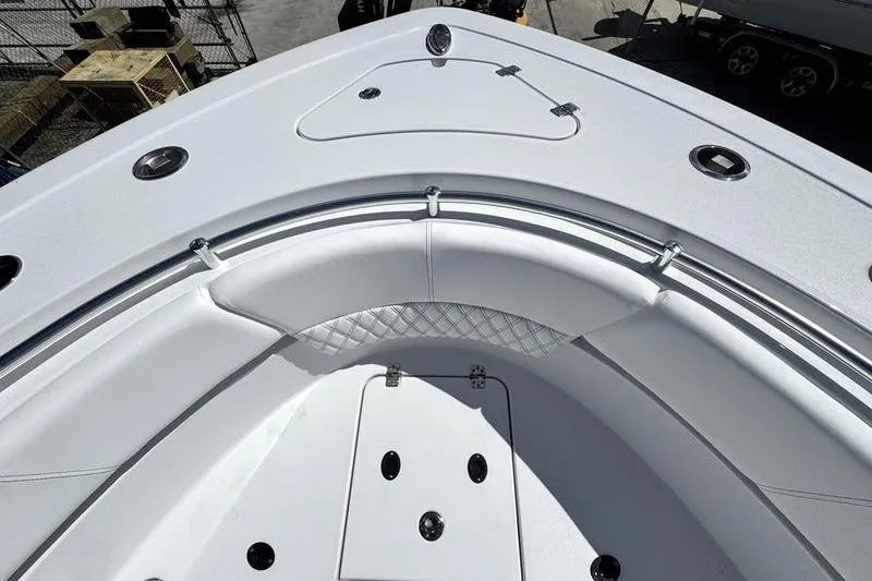 Slide: The Image of 2026 Sportsman Heritage 321 Center Console boat interior with sleek white seating and storage compartments. - 2