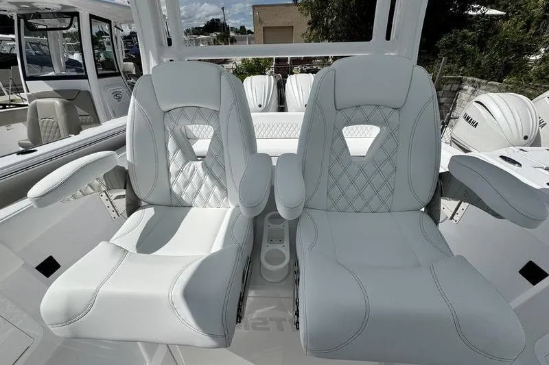 Slide: The Image of Luxurious seating on 2026 Sportsman Heritage 321 Center Console boat, featuring elegant white upholstery. - 21