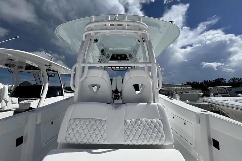 Slide: The Image of 2026 Sportsman Heritage 321 Center Console boat with sleek white seating and modern design. - 25