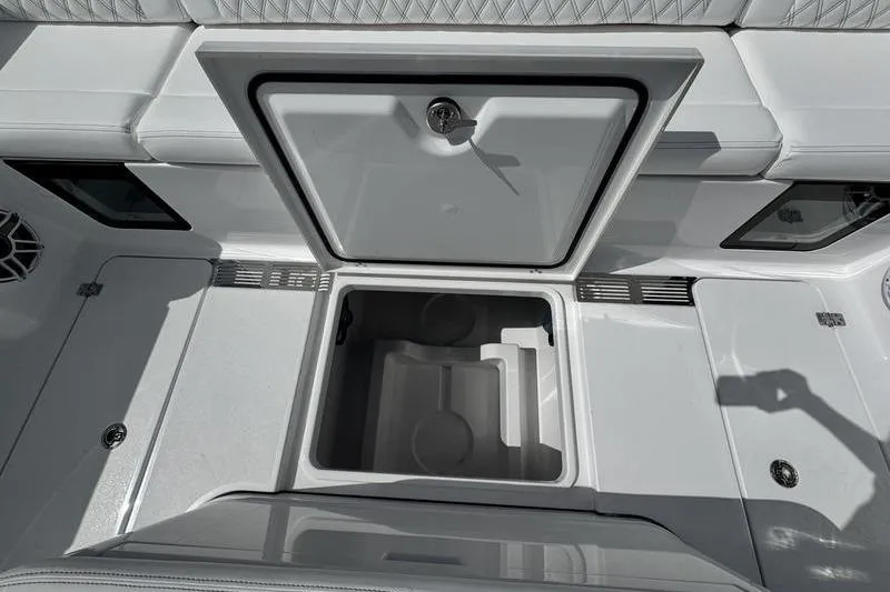 Slide: The Image of 2026 Sportsman Heritage 321 Center Console storage compartment, open and empty, with sleek design. - 26