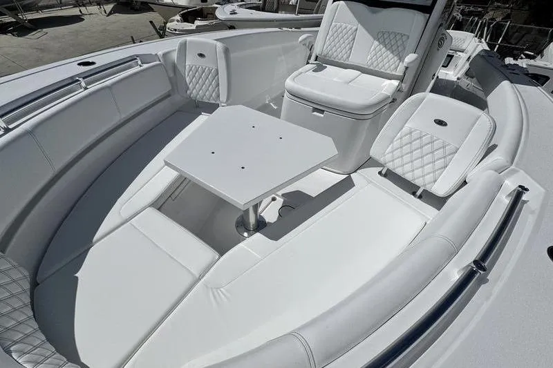 Slide: The Image of 2026 Sportsman Heritage 321 Center Console boat interior with white seating and table. - 5
