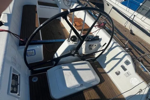 Slide: The Image of Cockpit of 2003 Grand Soleil 44 sailboat with steering wheel and wooden deck. - 17