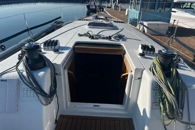 Slide: The Image of Grand Soleil 44 sailboat deck, 2003 model, with open cabin entrance and mooring ropes. - 24