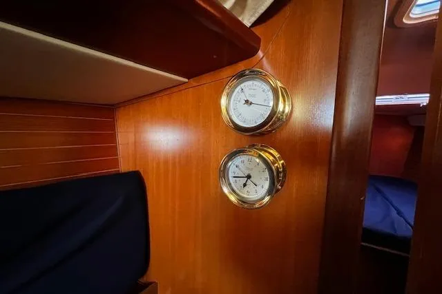 Slide: The Image of Interior of 2003 Grand Soleil 44 yacht with brass instruments on wooden paneling. - 26
