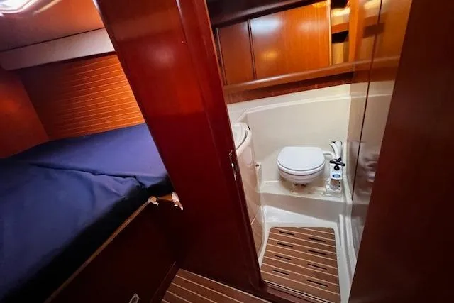 Slide: The Image of Grand Soleil 44 yacht interior, 2003 model, featuring a cozy cabin and compact bathroom. - 28