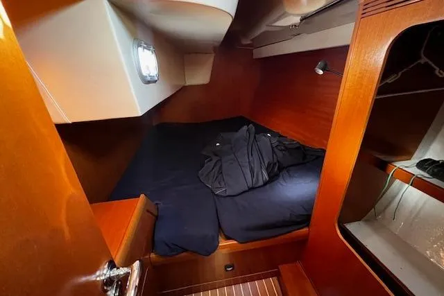 Slide: The Image of Cozy cabin interior of 2003 Grand Soleil 44 sailboat with wooden finish and bedding. - 29