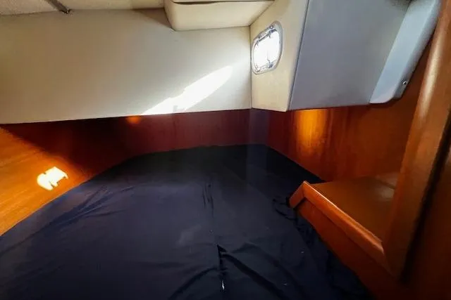 Slide: The Image of Cozy cabin interior of 2003 Grand Soleil 44 sailboat with wooden accents and porthole. - 34
