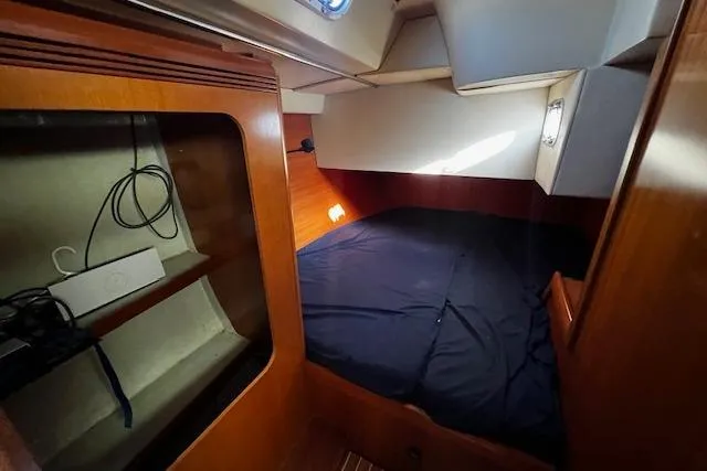 Slide: The Image of Cozy cabin interior of 2003 Grand Soleil 44 sailboat with wooden finish and bedding. - 35