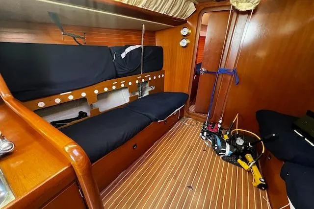 Slide: The Image of Interior of 2003 Grand Soleil 44 sailboat with wooden finish and black seating. - 37