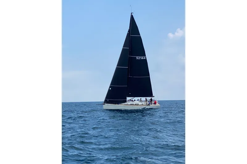 Slide: The Image of Sailing yacht Grand Soleil 44, 2003 model, with black sails on open sea. - 40