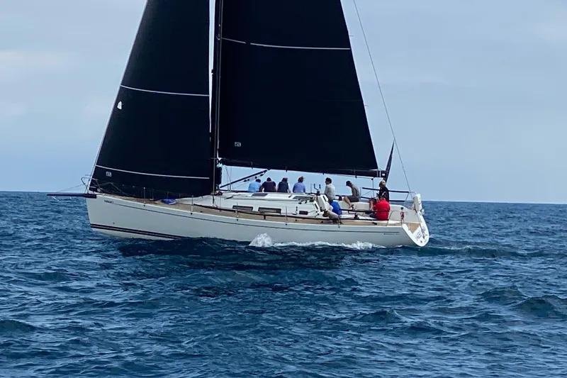 Slide: The Image of Sailing yacht Grand Soleil 44, 2003 model, with black sails on open sea. - 41