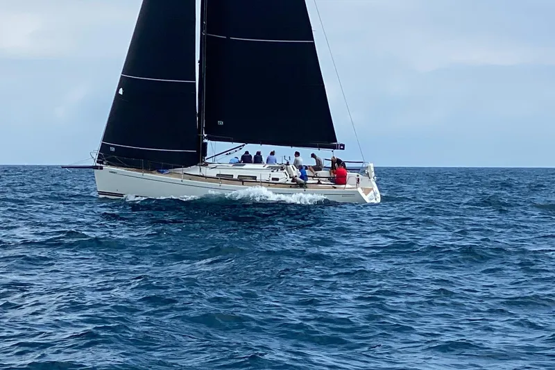 Slide: The Image of Sailing yacht Grand Soleil 44, 2003 model, cruising on open sea with black sails. - 42