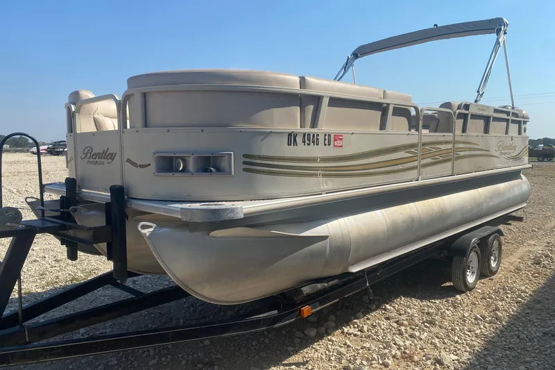 Slide: The Image of 2008 Bentley Pontoons Prestige 223LC on trailer, beige seating, outdoor setting. - 2